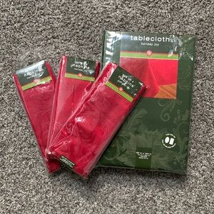 Holiday Joy Christmas green tablecloth 60 x 144 in with set of 12 red napkins.